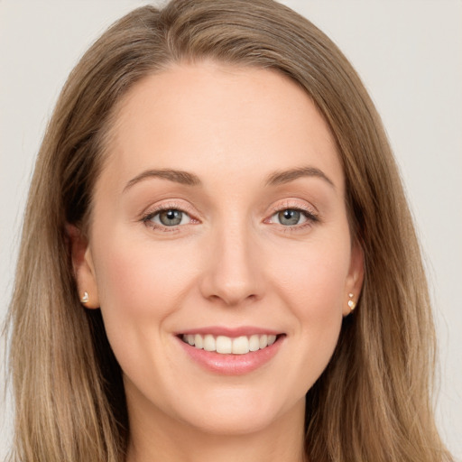 Joyful white young-adult female with long  brown hair and green eyes