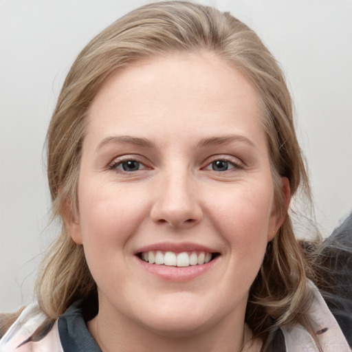 Joyful white young-adult female with medium  brown hair and blue eyes