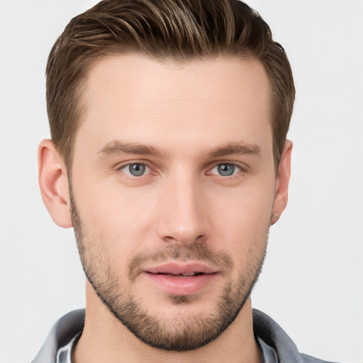 Joyful white young-adult male with short  brown hair and grey eyes