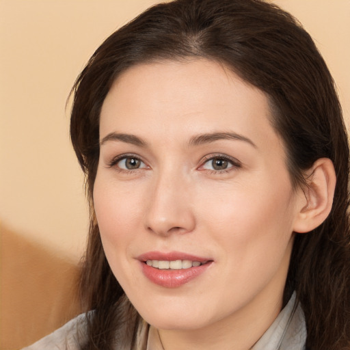 Joyful white young-adult female with medium  brown hair and brown eyes