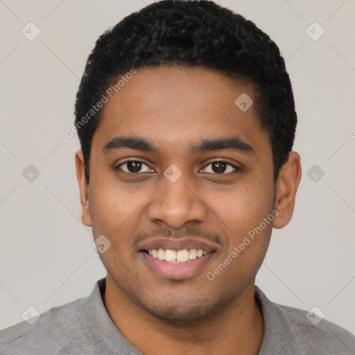 Joyful black young-adult male with short  black hair and brown eyes