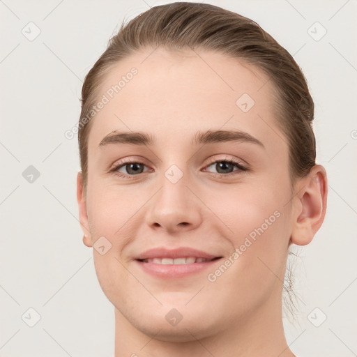 Joyful white young-adult female with short  brown hair and grey eyes