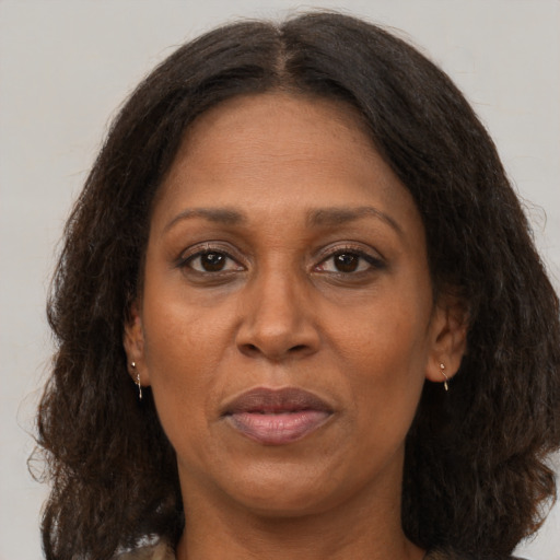 Joyful black adult female with medium  brown hair and brown eyes