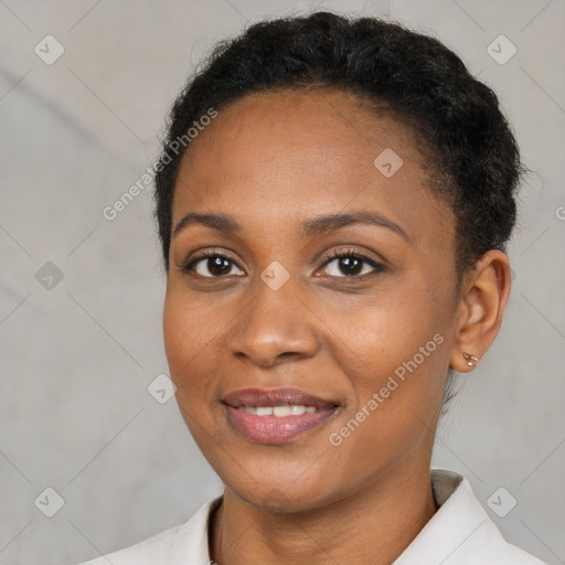 Joyful black young-adult female with short  black hair and brown eyes