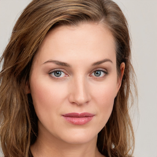 Joyful white young-adult female with long  brown hair and grey eyes