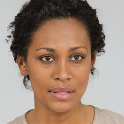 Joyful black adult female with short  brown hair and brown eyes