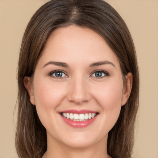 Joyful white young-adult female with long  brown hair and green eyes