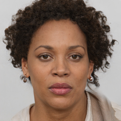 Joyful black adult female with medium  brown hair and brown eyes