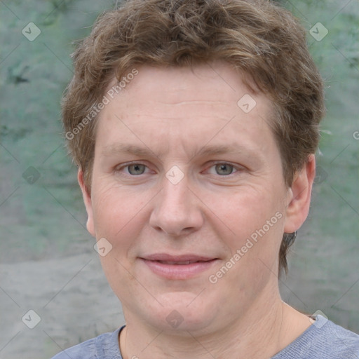 Joyful white adult male with short  brown hair and grey eyes