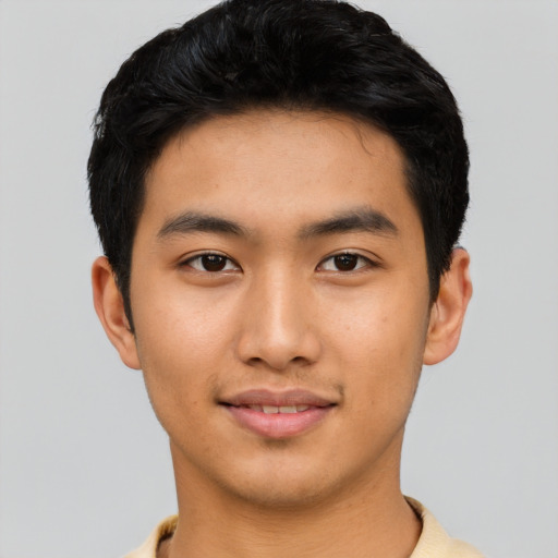 Joyful asian young-adult male with short  black hair and brown eyes