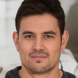 Joyful white young-adult male with short  brown hair and brown eyes