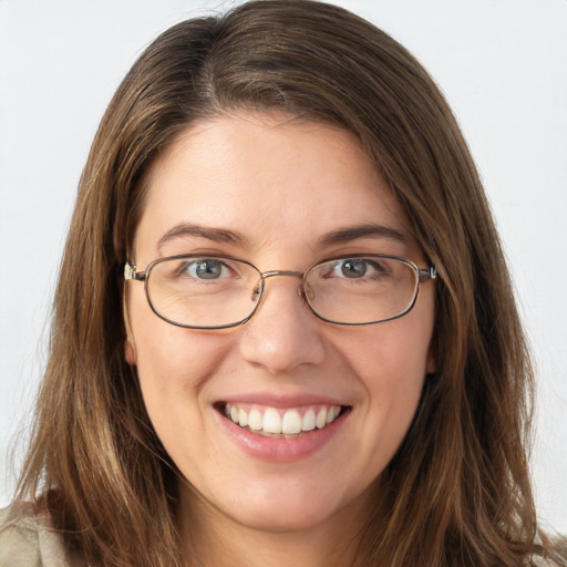 Joyful white young-adult female with long  brown hair and blue eyes