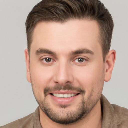 Joyful white young-adult male with short  brown hair and brown eyes