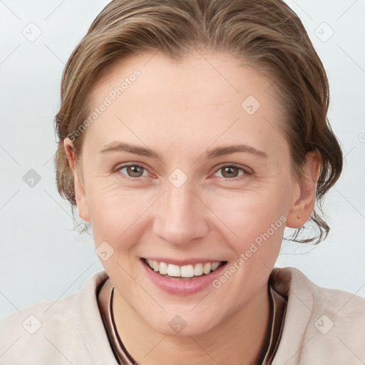 Joyful white young-adult female with medium  brown hair and grey eyes