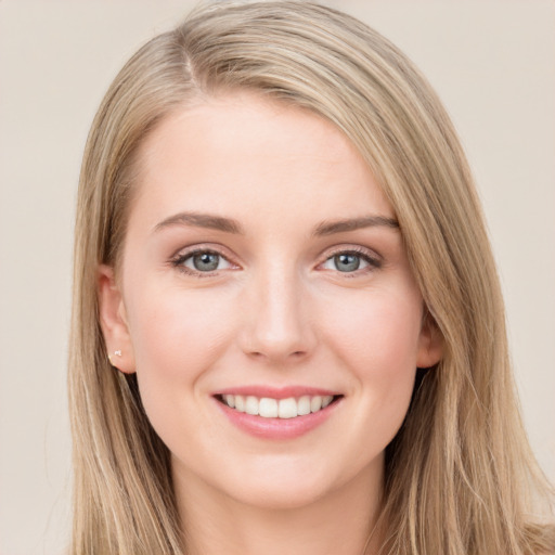 Joyful white young-adult female with long  brown hair and grey eyes