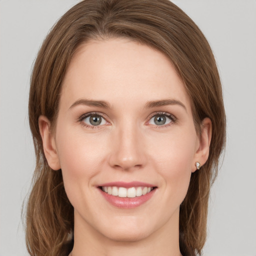 Joyful white young-adult female with medium  brown hair and green eyes