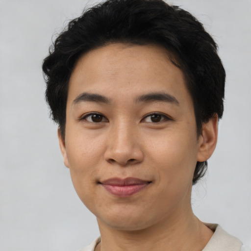 Joyful asian young-adult female with short  brown hair and brown eyes