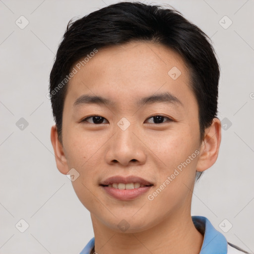 Joyful asian young-adult male with short  brown hair and brown eyes