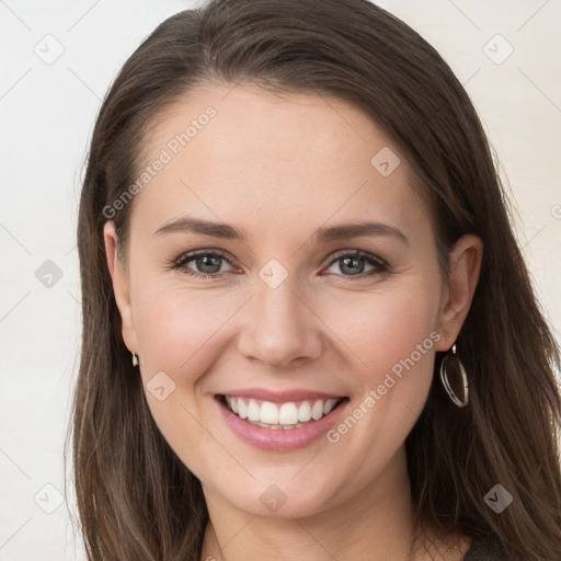 Joyful white young-adult female with long  brown hair and grey eyes