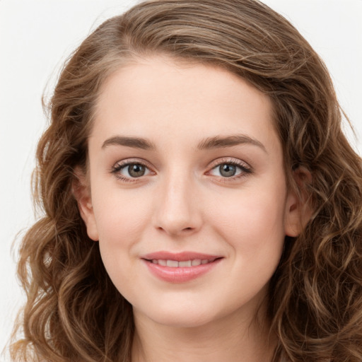 Joyful white young-adult female with long  brown hair and green eyes