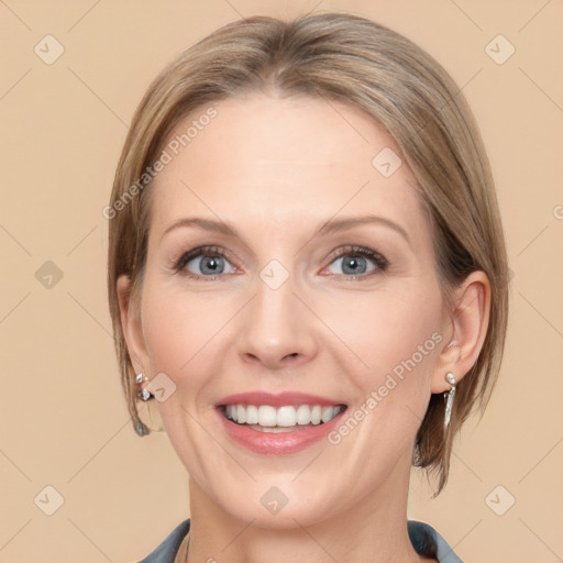 Joyful white adult female with medium  brown hair and blue eyes