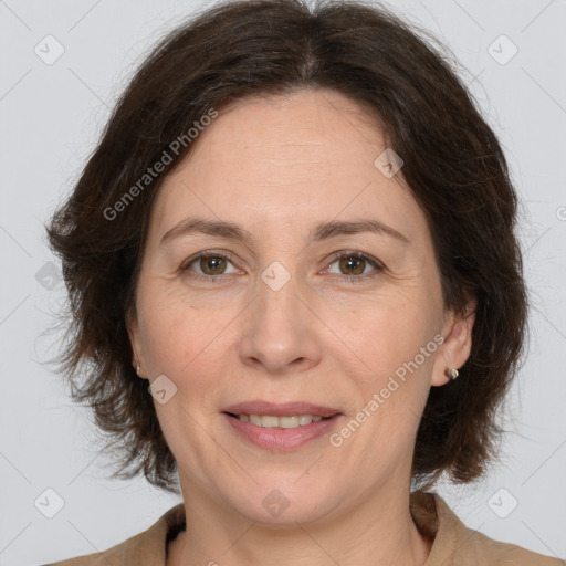 Joyful white adult female with medium  brown hair and brown eyes