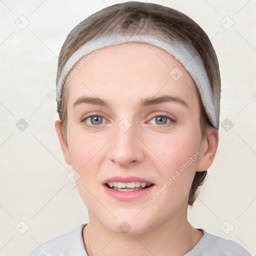 Joyful white young-adult female with short  brown hair and grey eyes