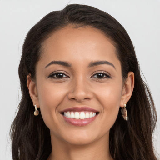 Joyful white young-adult female with long  brown hair and brown eyes