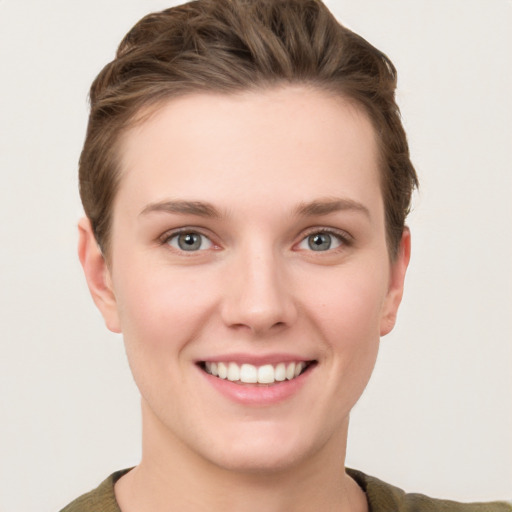 Joyful white young-adult female with short  brown hair and grey eyes