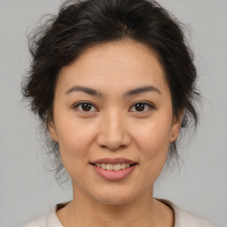 Joyful asian young-adult female with medium  brown hair and brown eyes