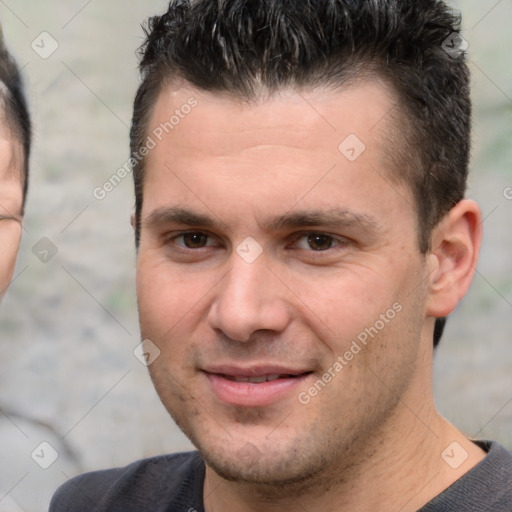 Joyful white young-adult male with short  brown hair and brown eyes