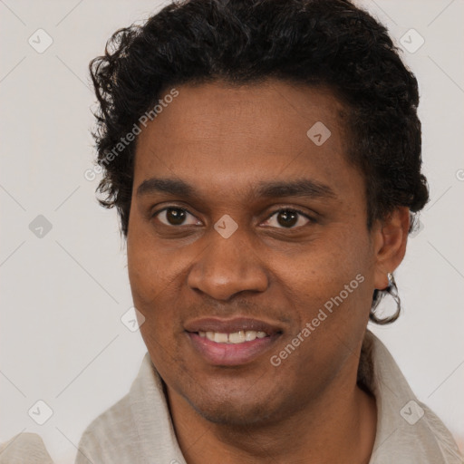 Joyful black young-adult male with short  black hair and brown eyes