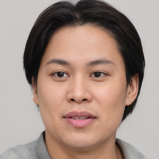 Joyful asian young-adult male with medium  brown hair and brown eyes