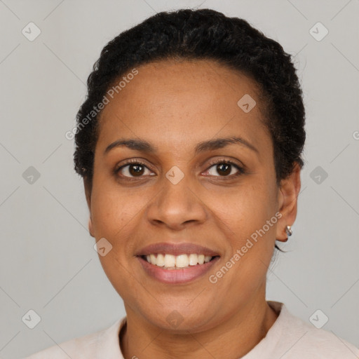 Joyful latino adult female with short  black hair and brown eyes