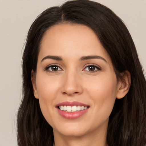 Joyful white young-adult female with long  brown hair and brown eyes