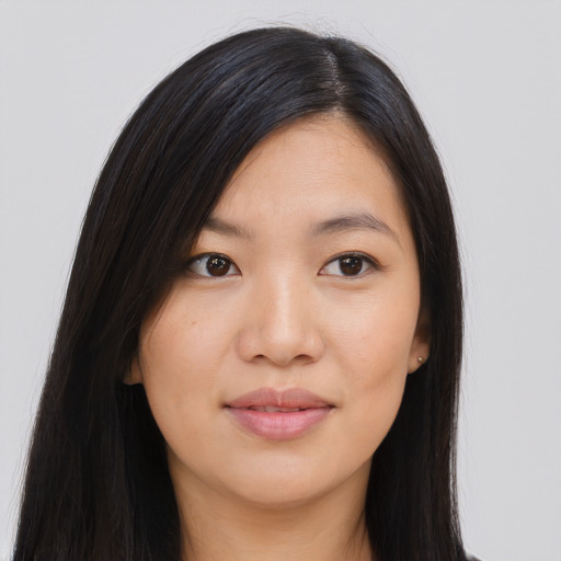 Joyful asian young-adult female with long  black hair and brown eyes