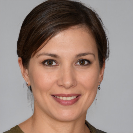 Joyful white young-adult female with medium  brown hair and brown eyes