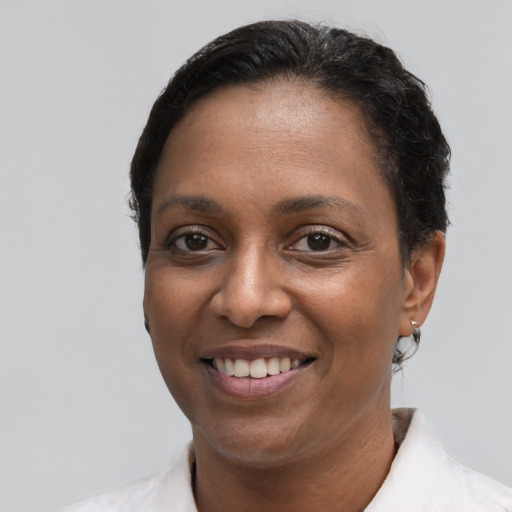 Joyful black young-adult female with short  brown hair and brown eyes