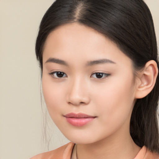 Joyful asian young-adult female with long  brown hair and brown eyes