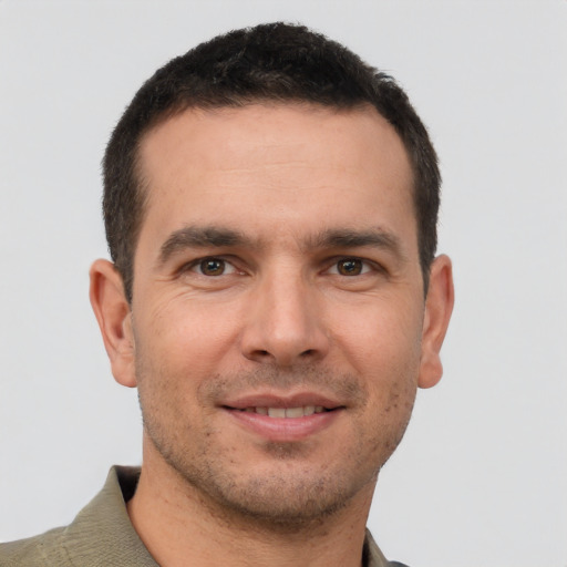 Joyful white young-adult male with short  brown hair and brown eyes