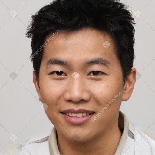 Joyful asian young-adult male with short  brown hair and brown eyes