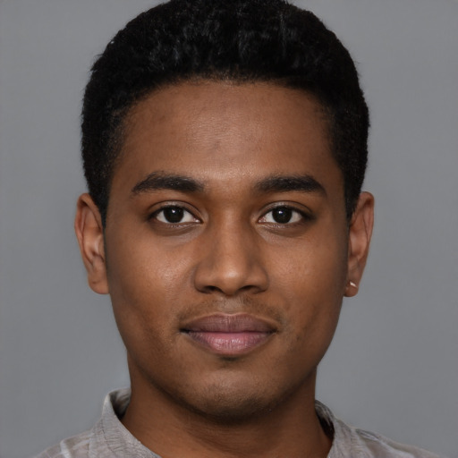 Joyful black young-adult male with short  black hair and brown eyes