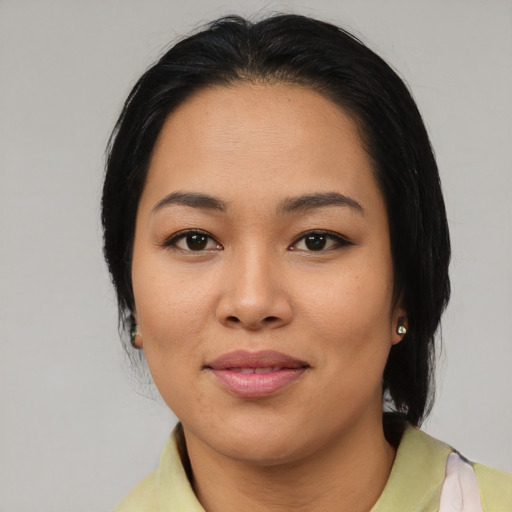 Joyful latino young-adult female with medium  black hair and brown eyes