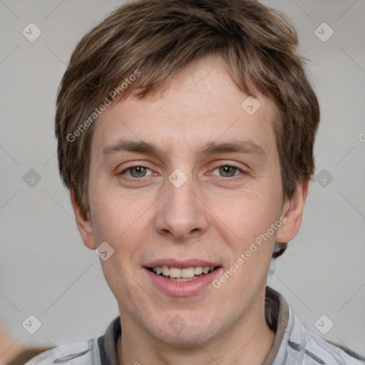 Joyful white adult male with short  brown hair and grey eyes