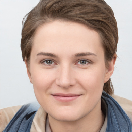 Joyful white young-adult female with short  brown hair and grey eyes