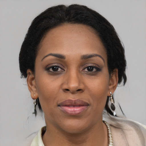 Joyful black adult female with short  brown hair and brown eyes