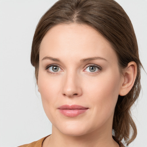 Joyful white young-adult female with medium  brown hair and blue eyes