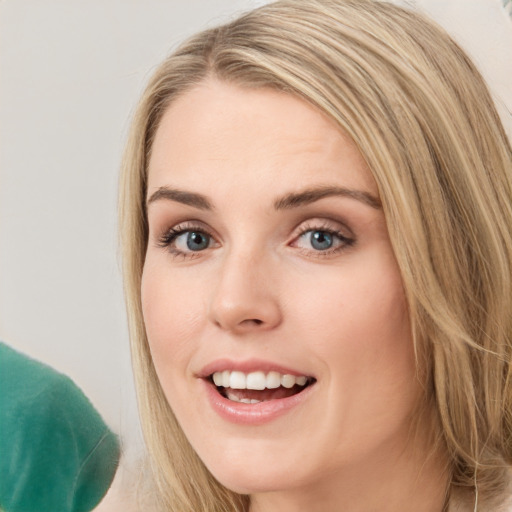 Joyful white young-adult female with long  brown hair and green eyes