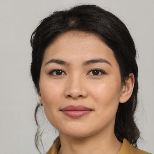 Joyful asian young-adult female with medium  brown hair and brown eyes