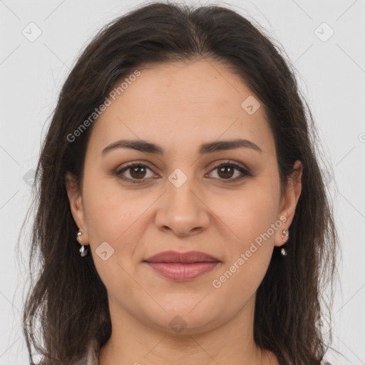 Joyful white adult female with long  brown hair and brown eyes